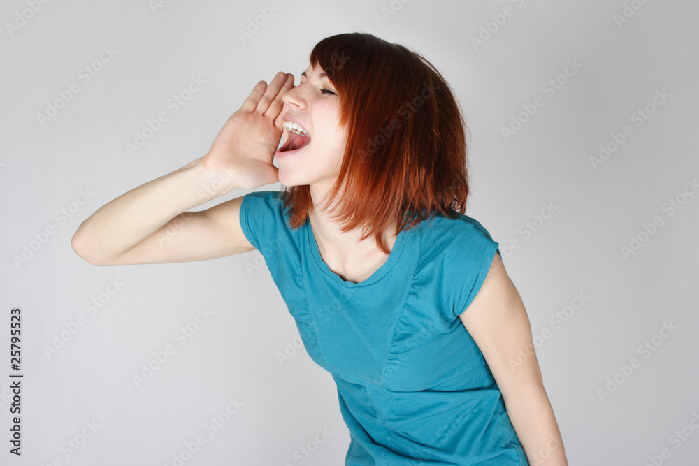 young redhead woman calling someone, hand near lips, side view, young redhead woman calling someone, hand near lips, side view,