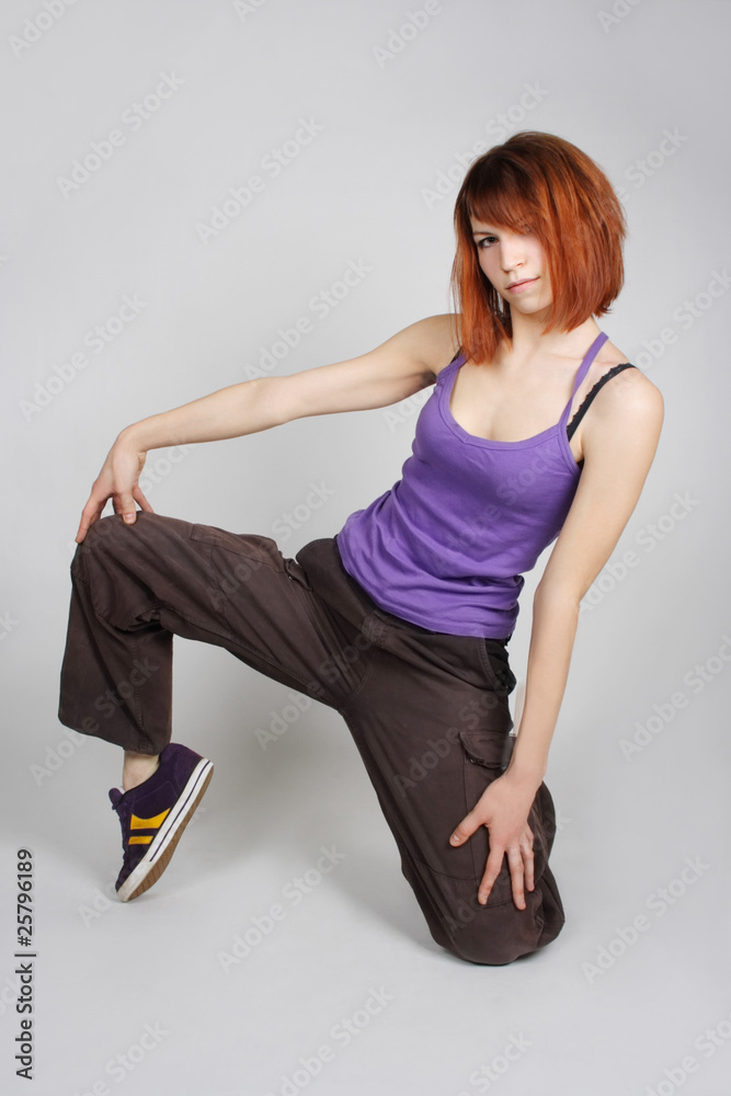 young redhead girl in hip-hop clothes sitting on one knee and lo young redhead girl in hip-hop clothes sitting on one knee and lo