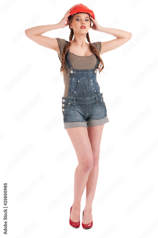 Young playful worker woman in coverall and helmet Young playful worker woman in coverall and helmet
