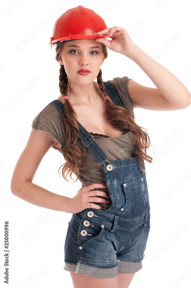 Young playful worker woman in coverall and helmet Young playful worker woman in coverall and helmet
