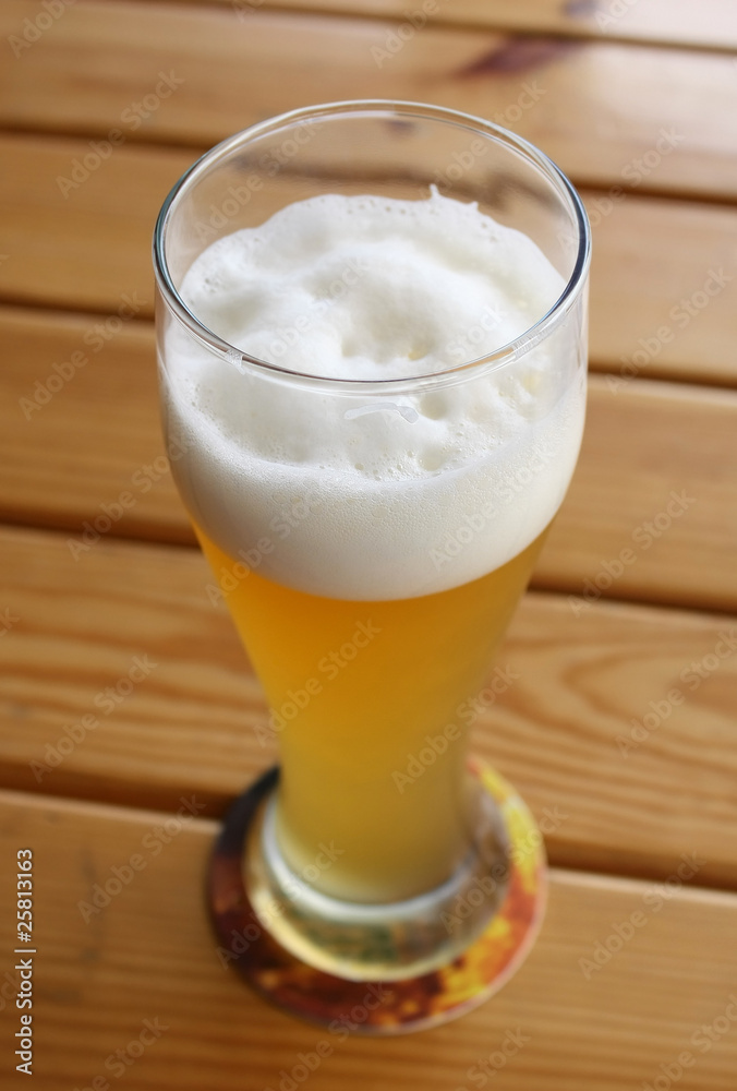 Beer in glass on a wooden table Beer in glass on a wooden table