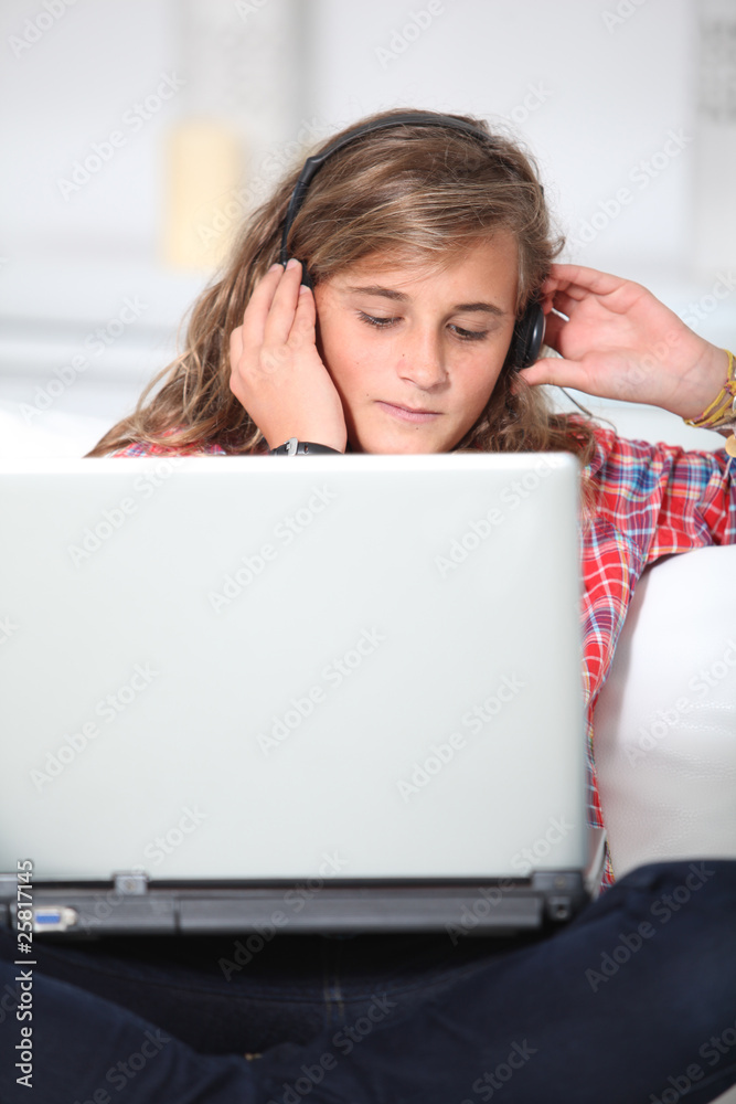 Teenager wth headphones and laptop computer Teenager wth headphones and laptop computer