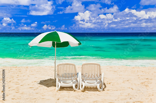 Fototapeta Naklejka Na Ścianę i Meble -  Chairs and umbrella at tropical beach