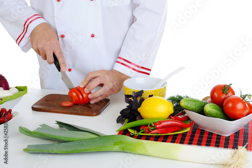 Fototapeta Naklejka Na Ścianę i Meble -  Chef cuts the vegetables