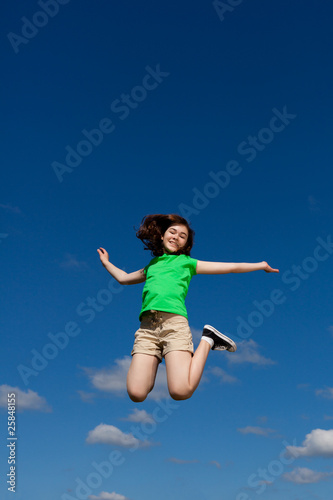 Girl jumping, running against blue sky © Jacek Chabraszewski