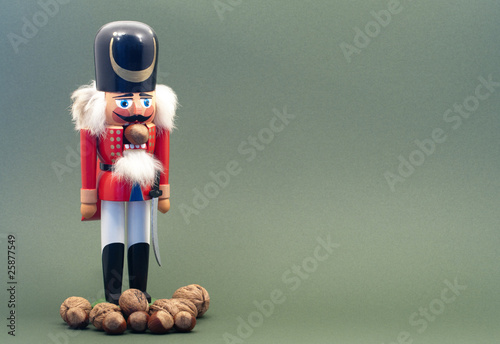 Wooden Nutcracker with Nuts Isolated on a Green Background.