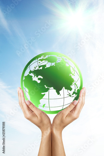 Hands holding a green earth