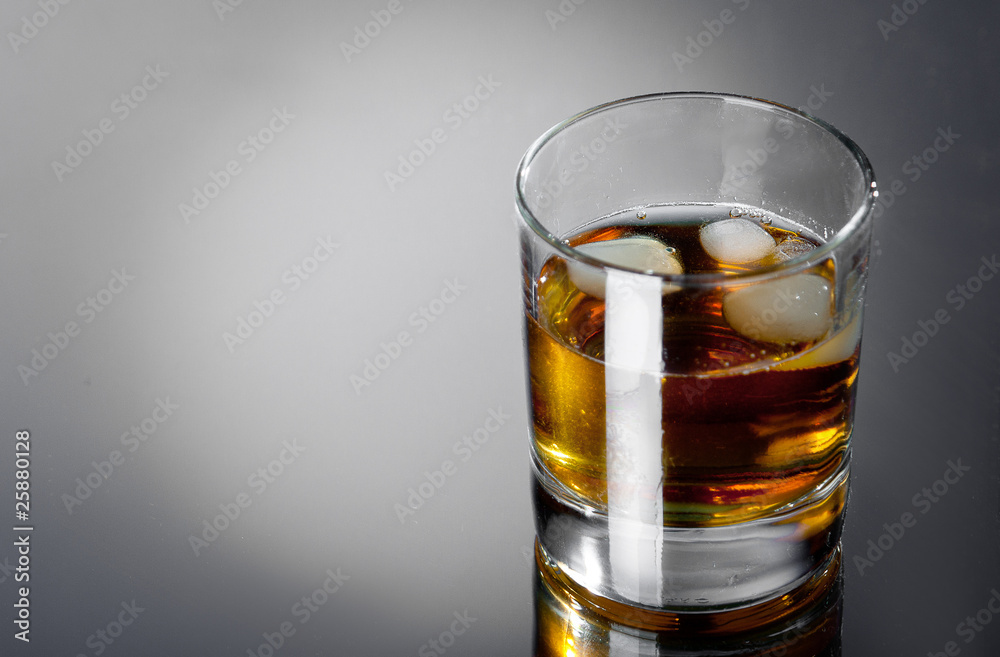 glass whisky on a grey bg