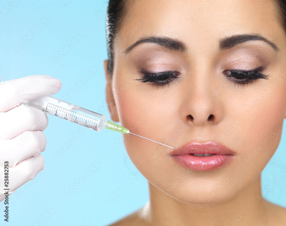 Beautiful woman gets botox injection in her face Stock Photo