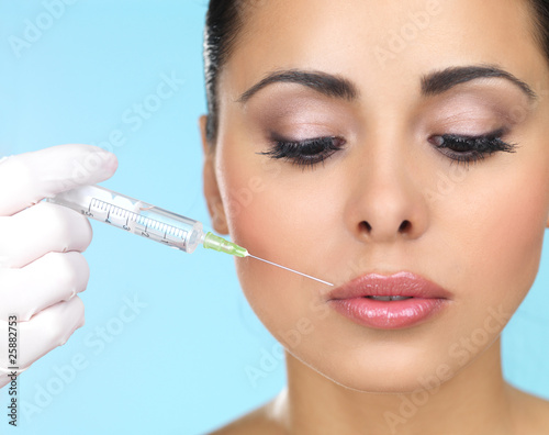 Beautiful woman gets botox injection in her face