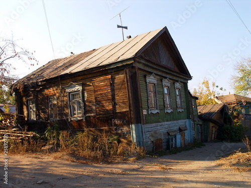An old village house against a blue sky in autumn photo