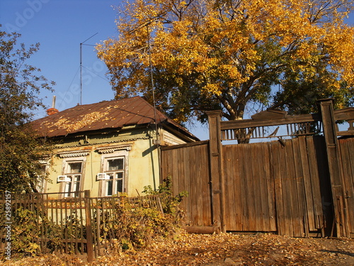 An old village house against a blue sky in autumn photo