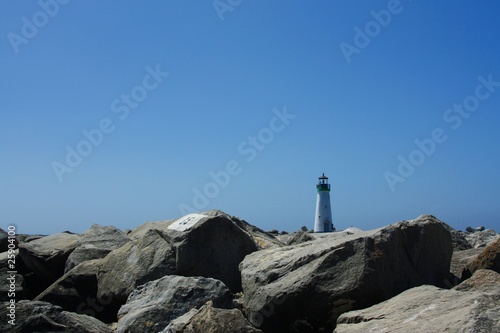 Rocks and Lighthouse in background
