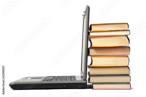 Stack of book and laptop over white