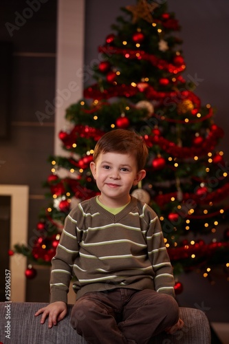 Little boy in front of christmas tree