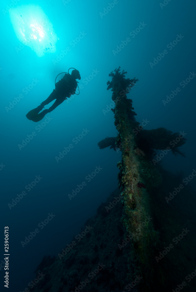 Female scuba diver exploring ship wreck Female scuba diver exploring ship wreck