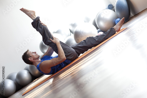 fusion of mind and body - man practicing pilates