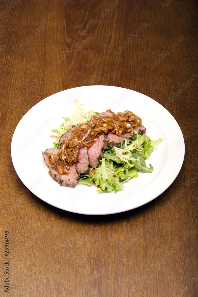 Meat served with salad and onion