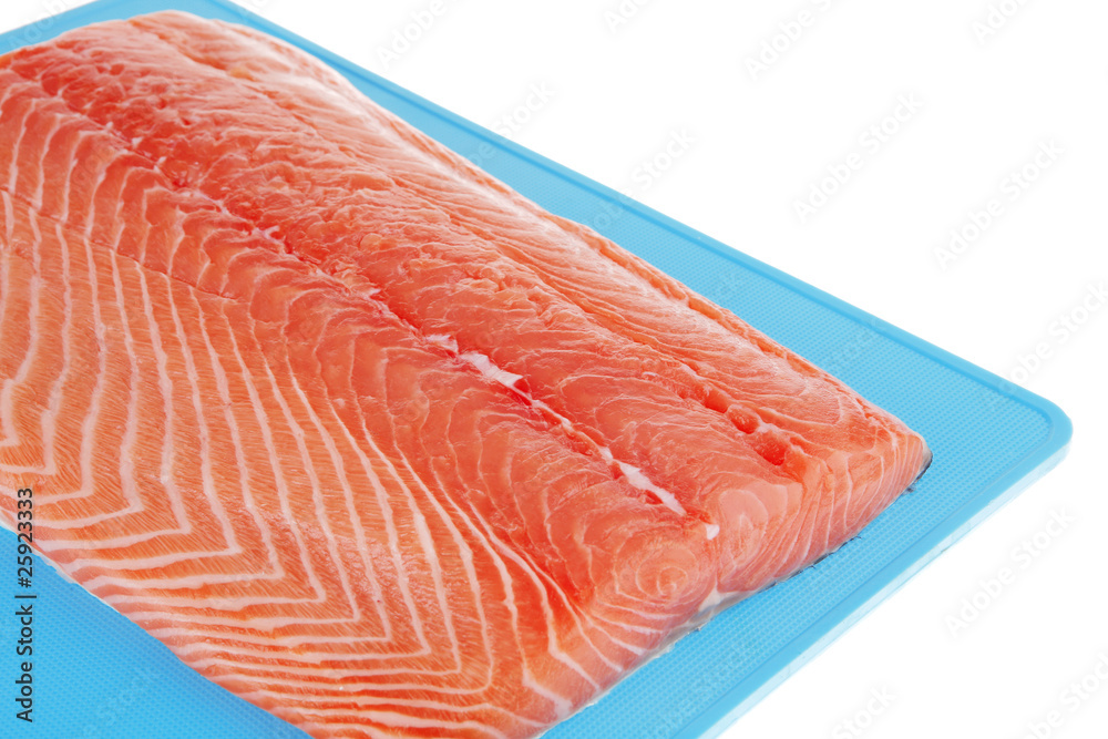raw salmon fillet on blue plate