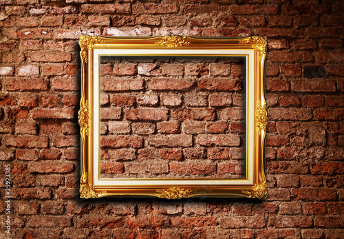 Golden frame against grunge brick wall