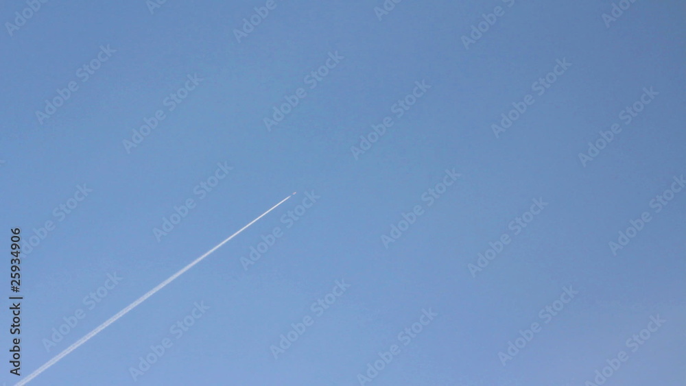 flying airplane with trail in blue sky flying airplane with trail in blue sky