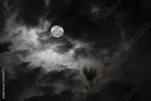 Spooky full moon and eerie white clouds