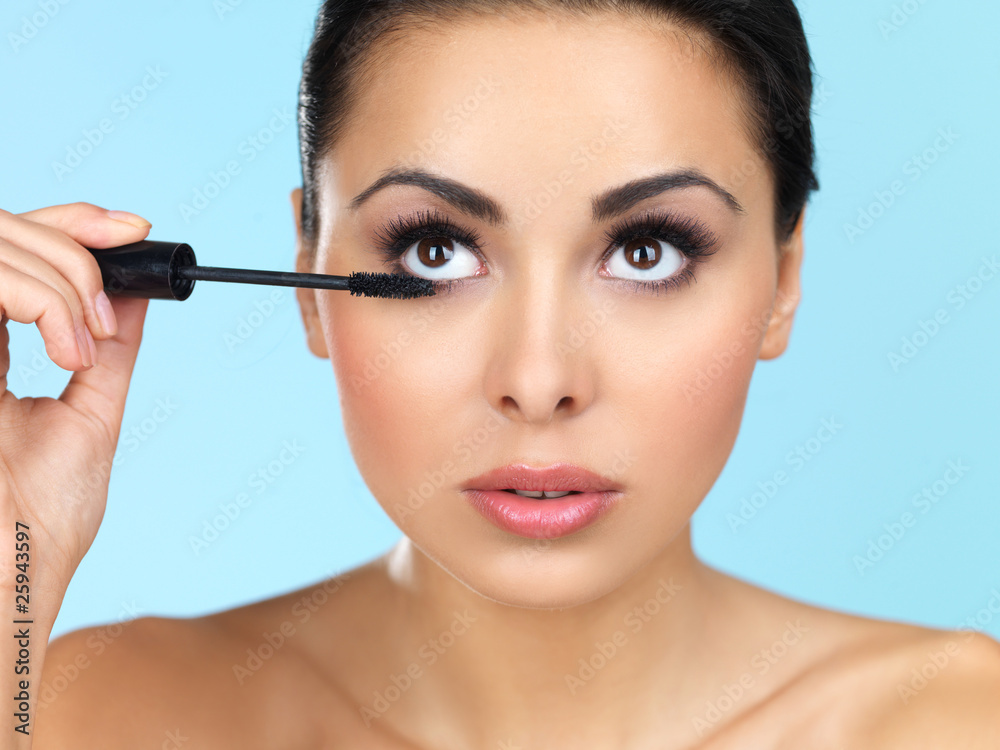 Portrait of beautiful woman she is doing makeup