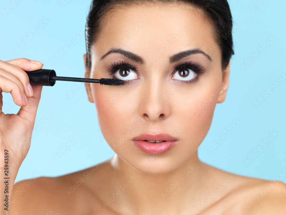 Portrait of beautiful woman she is doing makeup Portrait of beautiful woman she is doing makeup