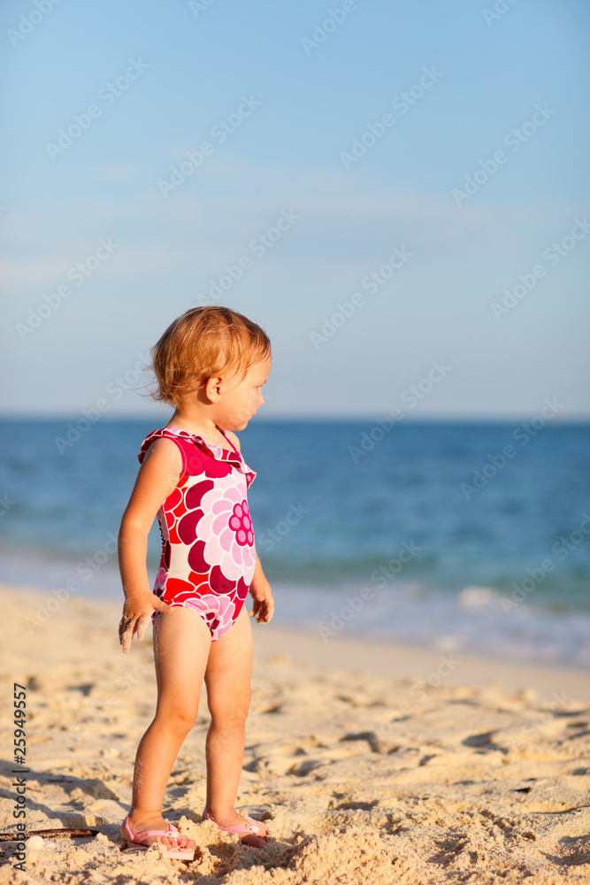Toddler girl on beach at sunset Toddler girl on beach at sunset