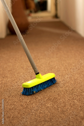 Plastic broom on carpet
