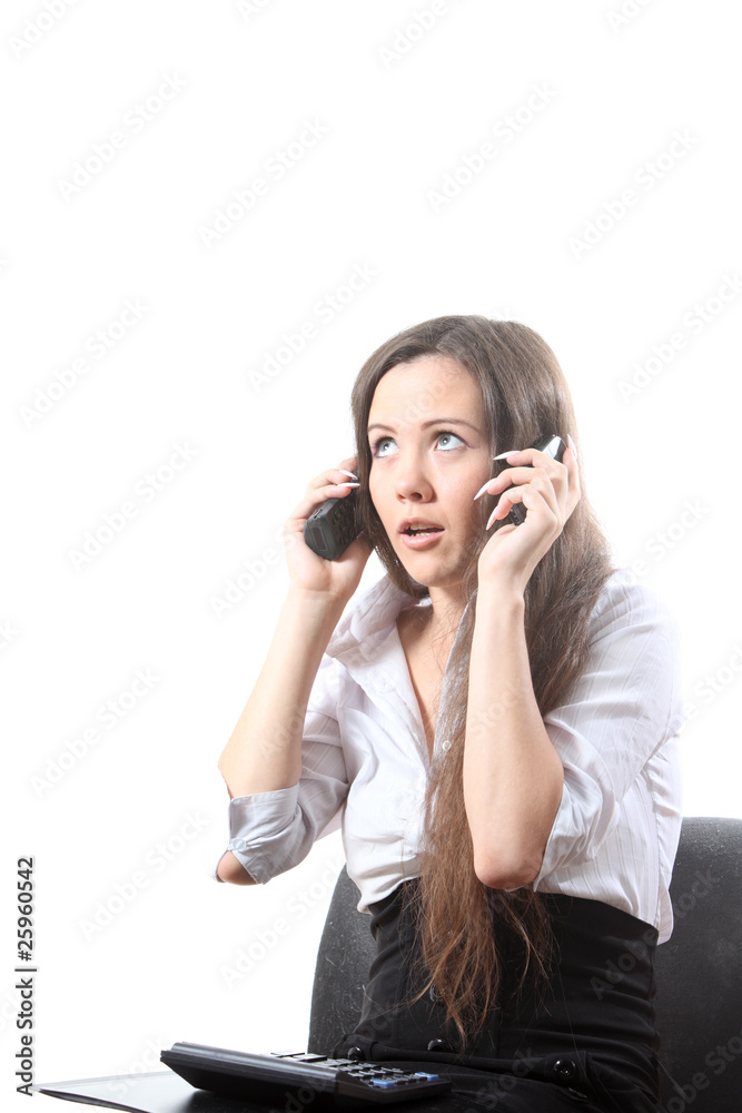 Surprised businesswoman speak by two phones Surprised businesswoman speak by two phones