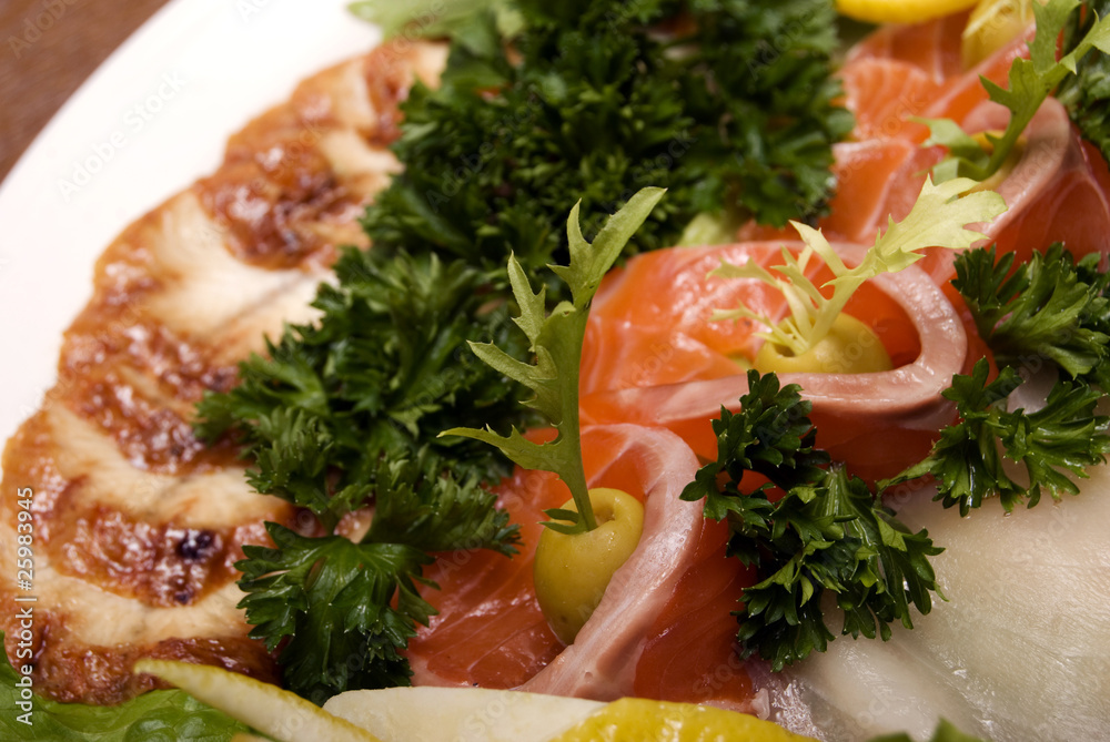 Appetizer made of meat and fish served with salad