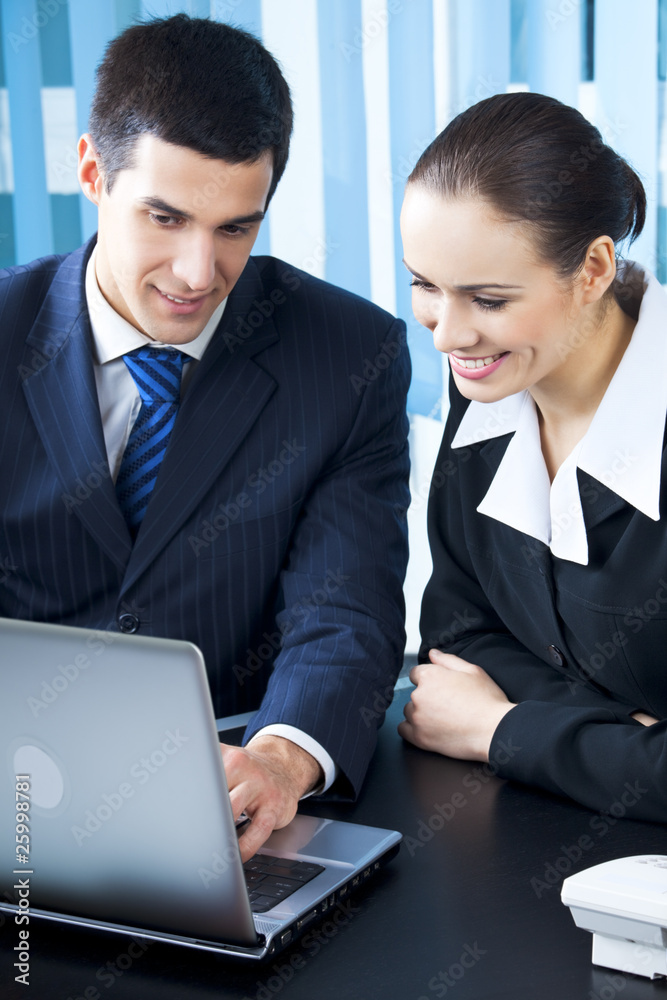 Two businesspeople working with laptop at office Two businesspeople working with laptop at office