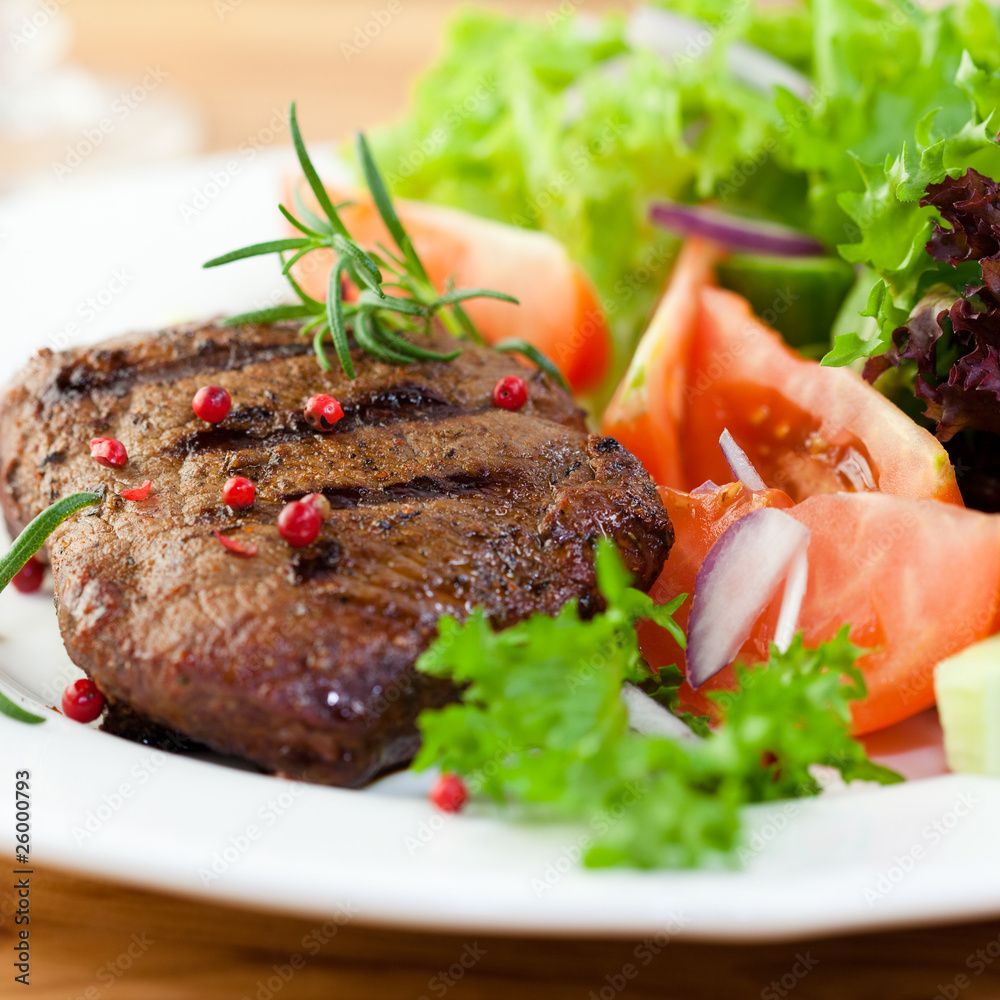 Grilled steak with fresh vegetables and herbs