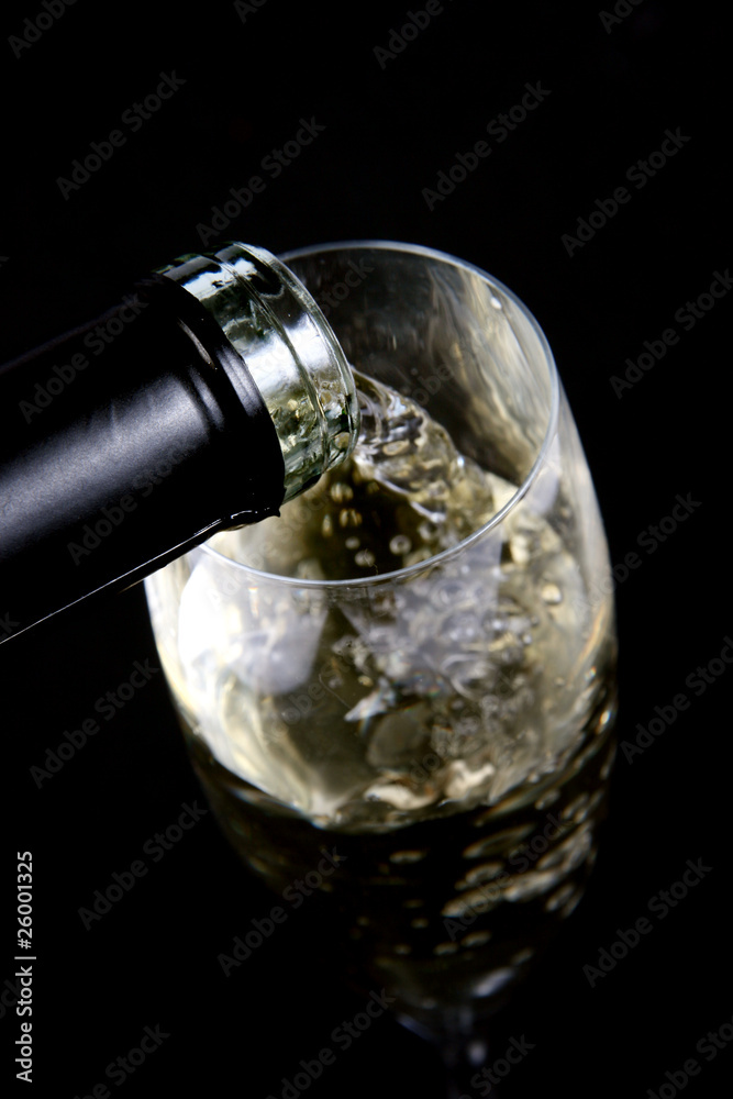 pouring white wine into the glass pouring white wine into the glass