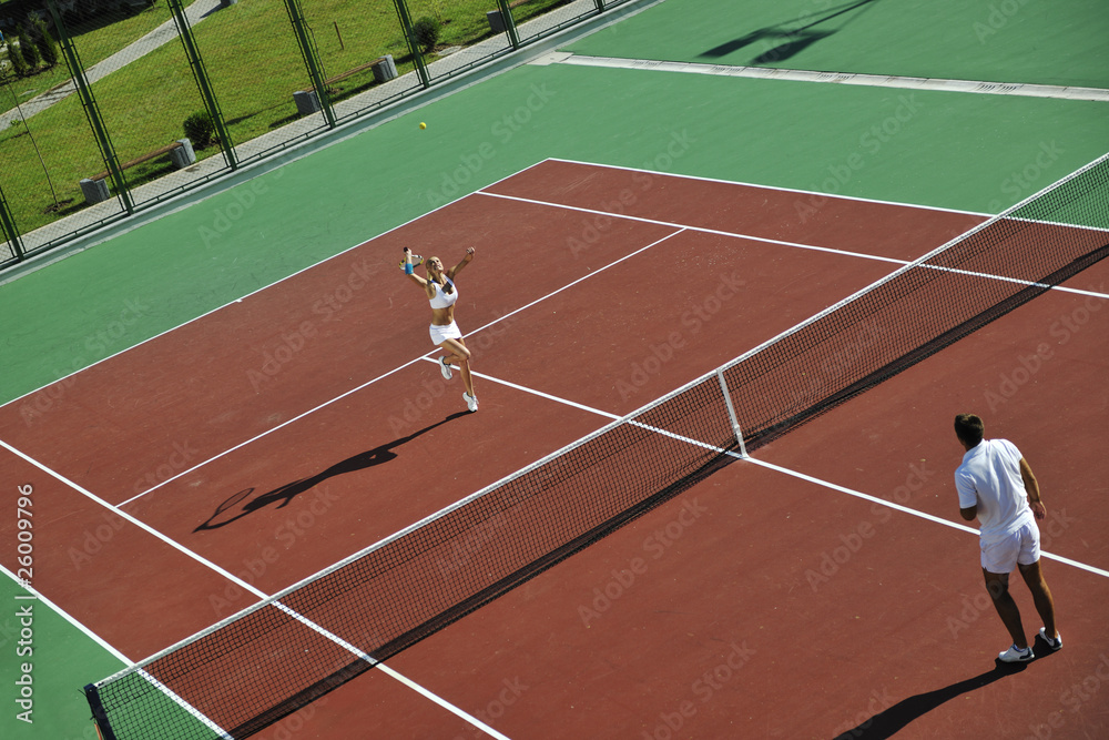 Fototapeta premium happy young couple play tennis game outdoor