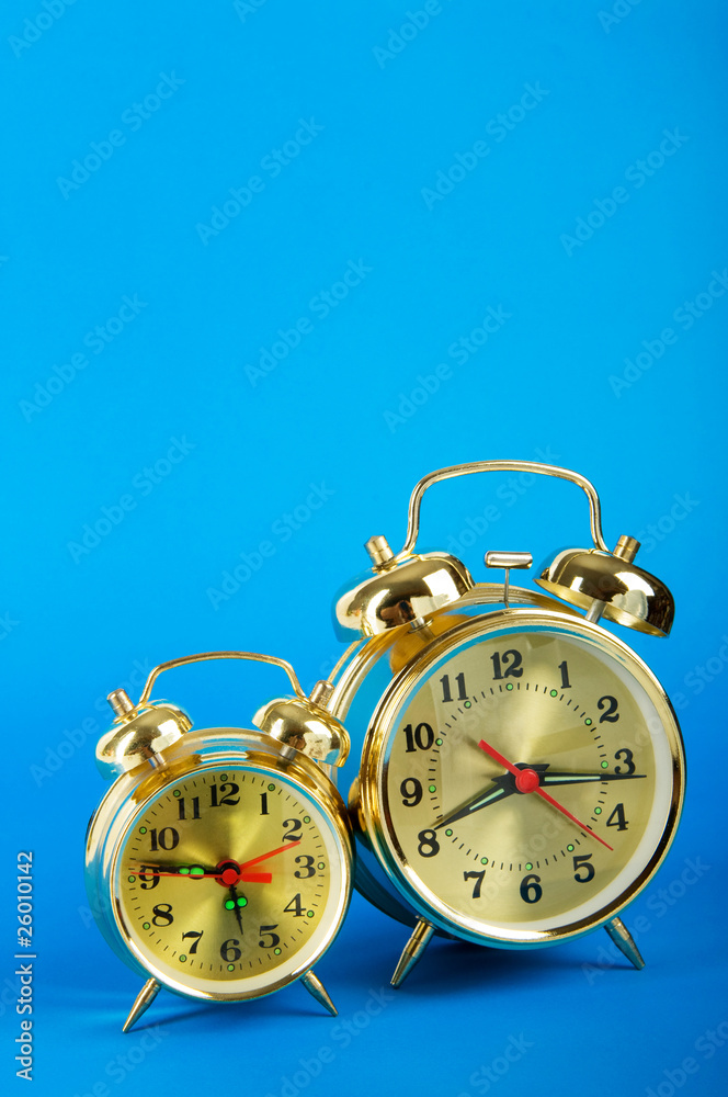 Time concept - alarm clock against colorful background Time concept - alarm clock against colorful background