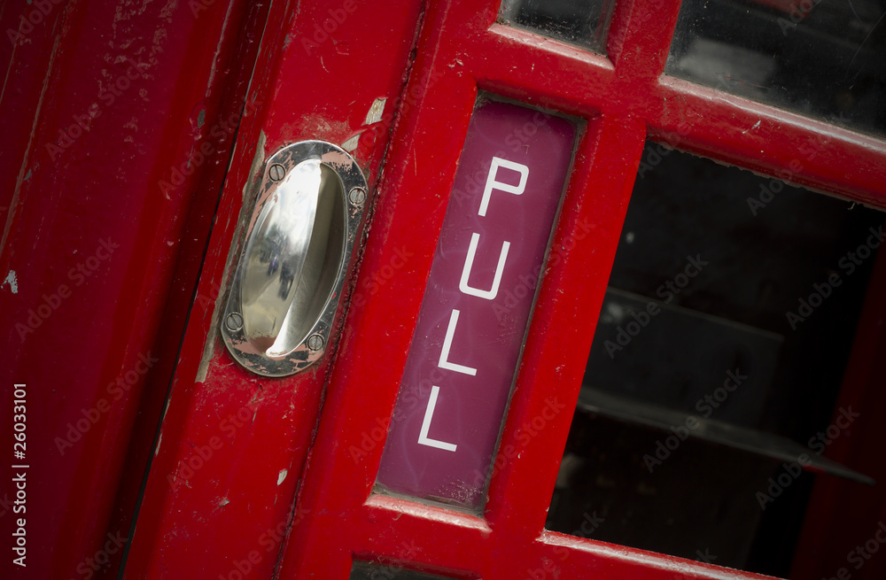 Fototapeta premium Pull sign on old telephone box