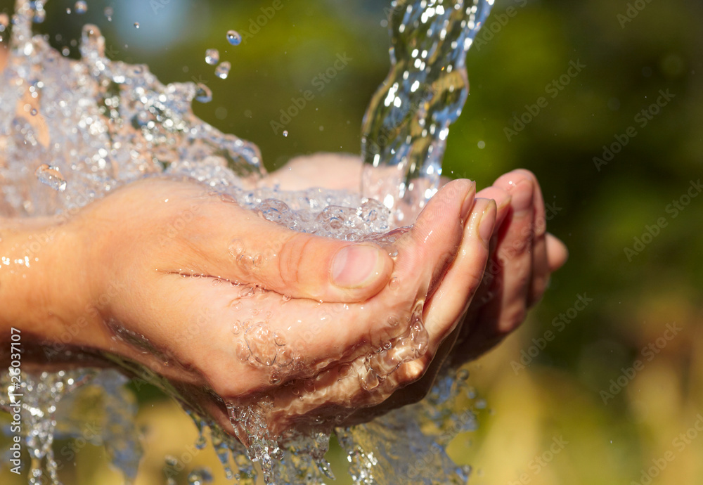 Fototapeta premium Woman's hands with water splash
