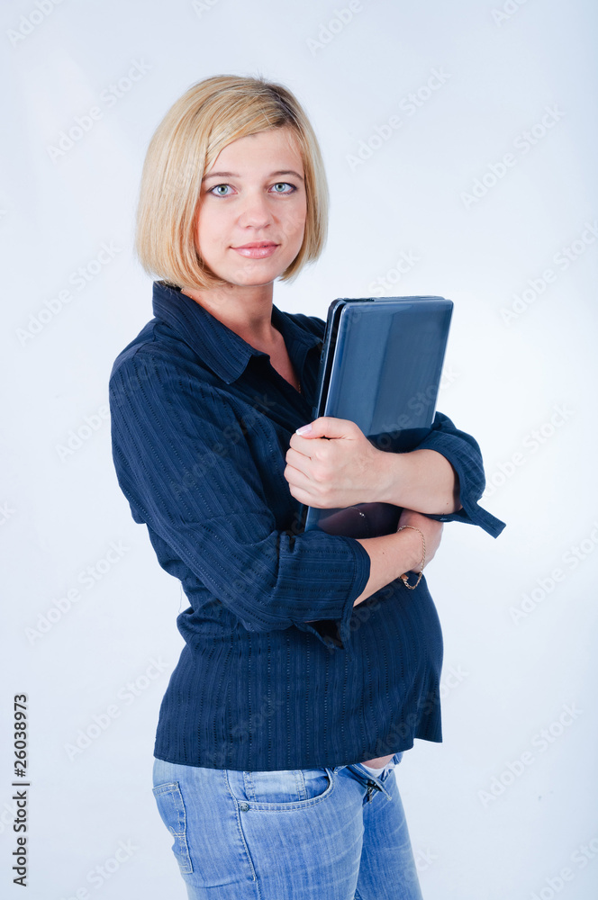 Naklejka premium Sweet pregnant girl with a laptop in the studio