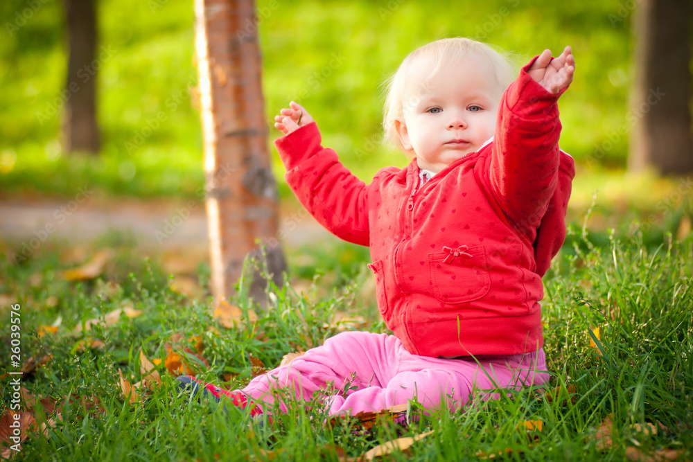 young adorable cheerful baby sit in park on green grass play wit young adorable cheerful baby sit in park on green grass play wit