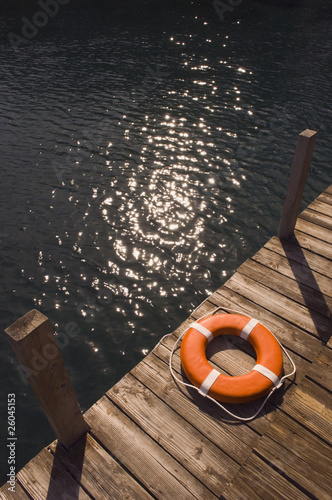 Round life preserver on wooden dock