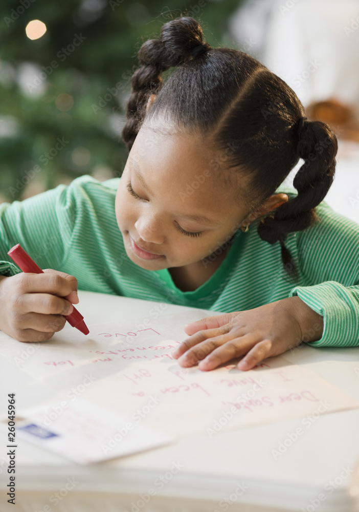 African American girl writing letter to Santa Claus African American girl writing letter to Santa Claus