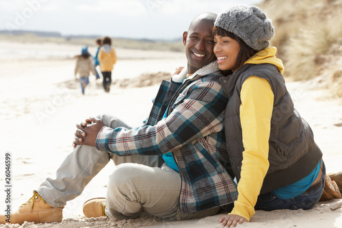 Family Having Fun On Winter Beach