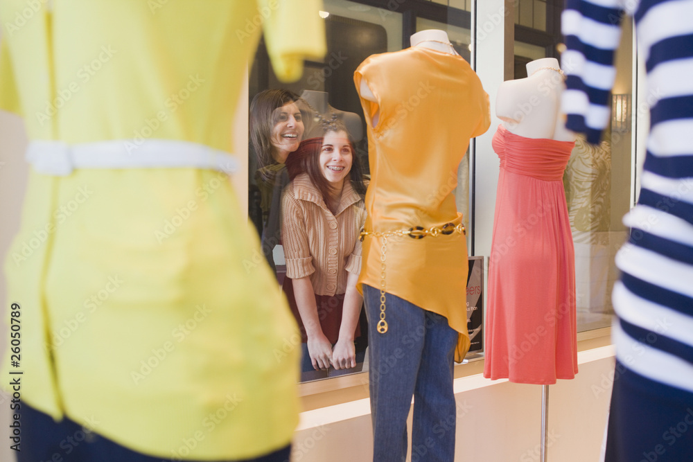 Middle Eastern mother and daughter window shopping Middle Eastern mother and daughter window shopping