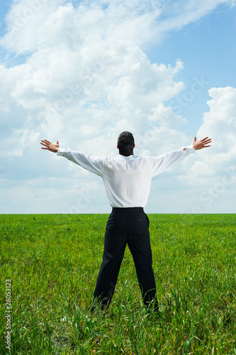 happy businessman in field