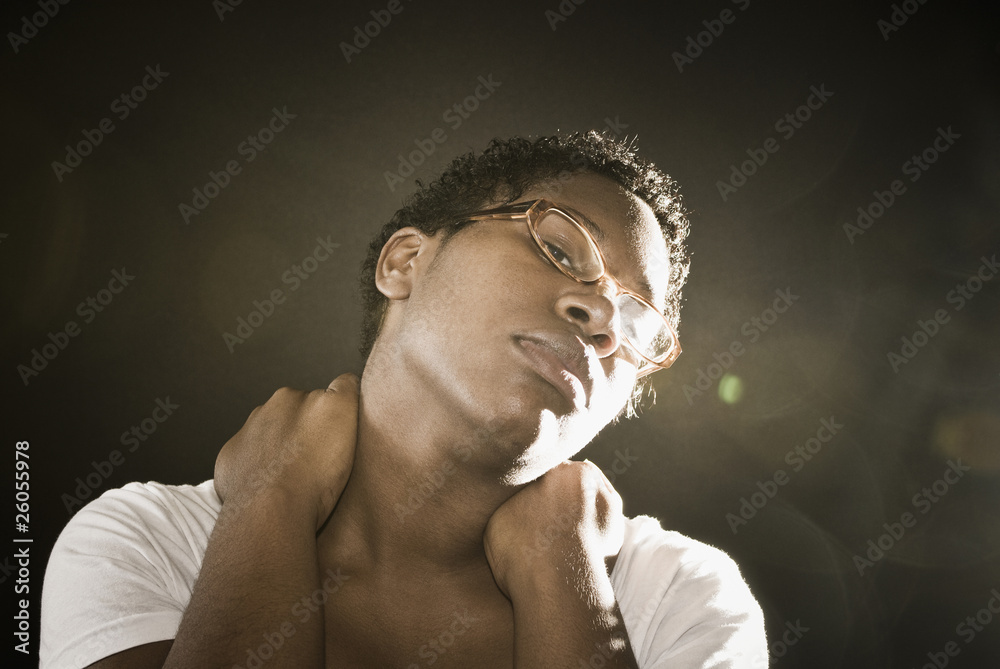 African woman rubbing neck