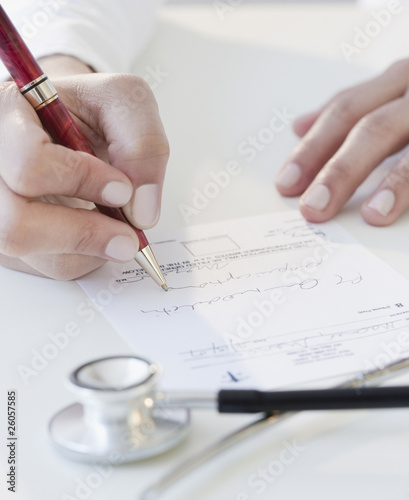 Doctor writing prescription photo