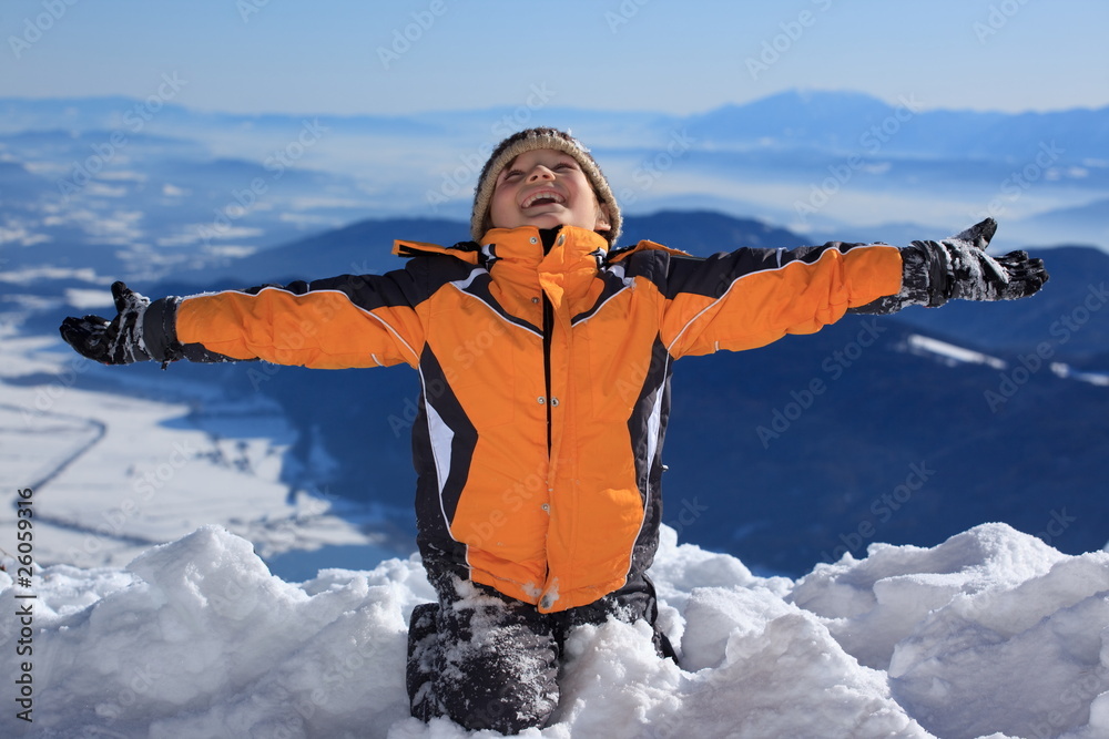 Happy boy on snowy mountain