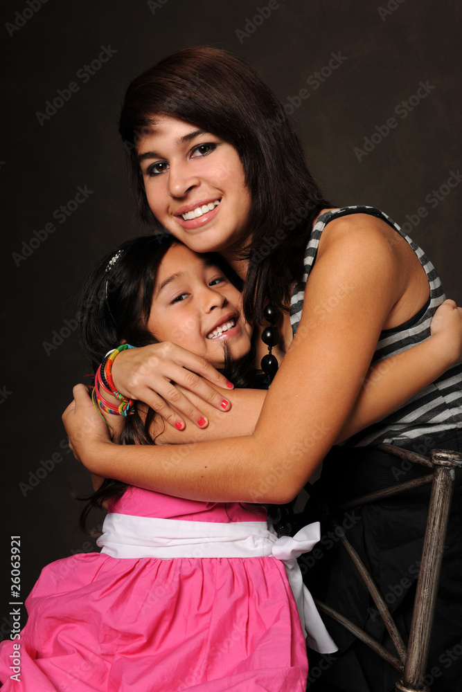 Obraz premium Young Girl and Teenager Embracing